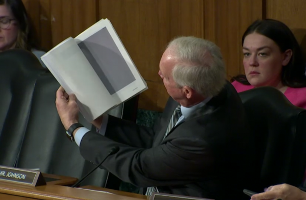 Sen. Johnson holds up redacted pages